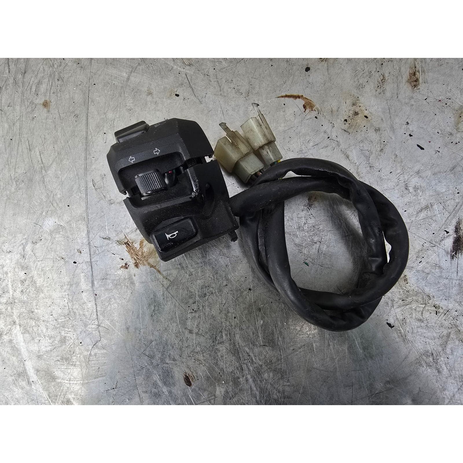 Front view of the left-hand handlebar control assembly showing indicator and horn switches