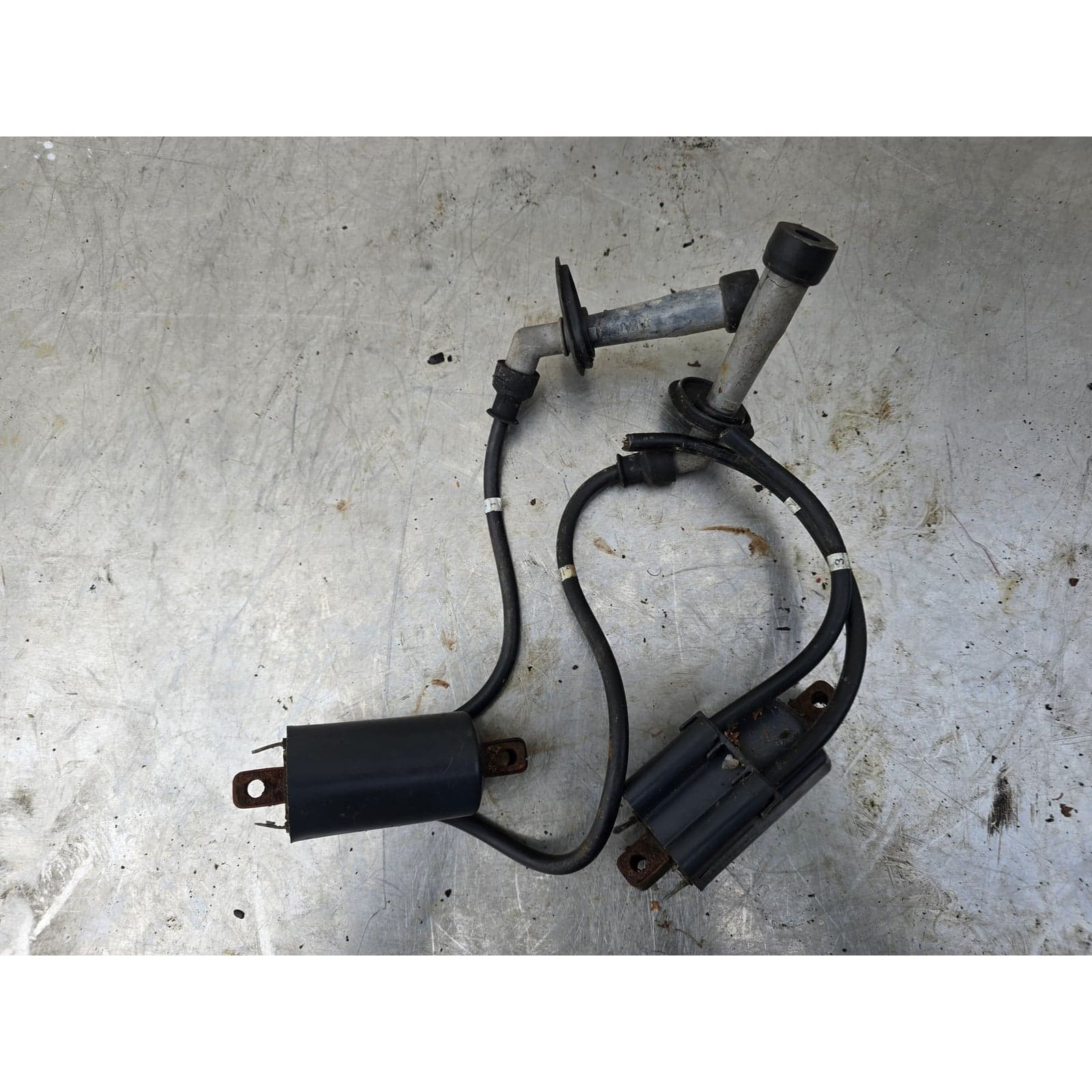 Top-down view of the Denso ignition coil set including both coils and spark plug caps.