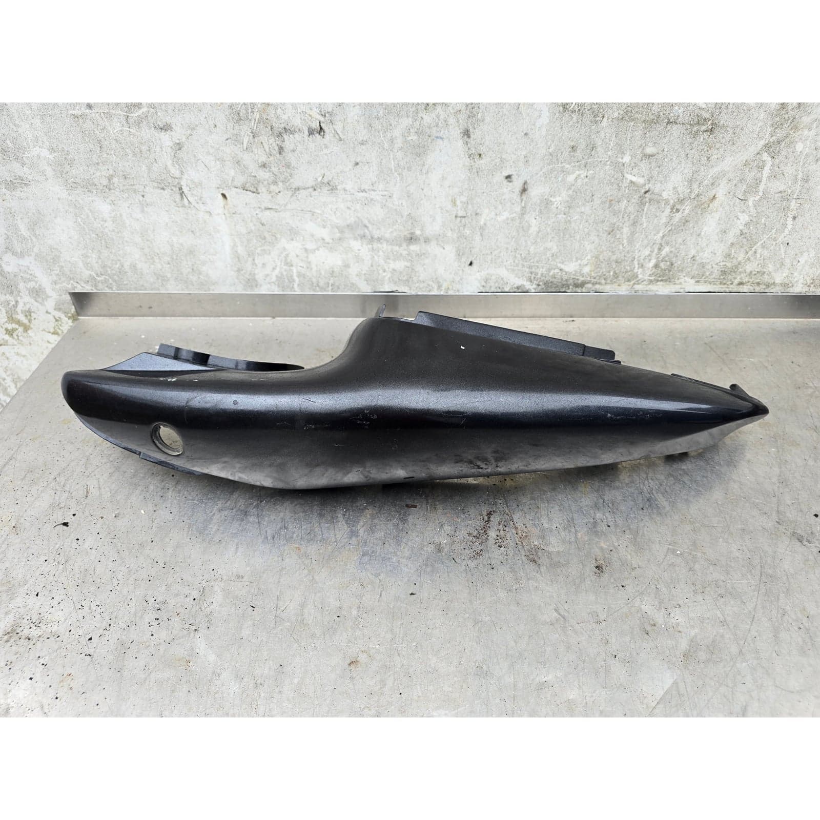 Full view of the left rear tail section fairing, displaying its complete shape.