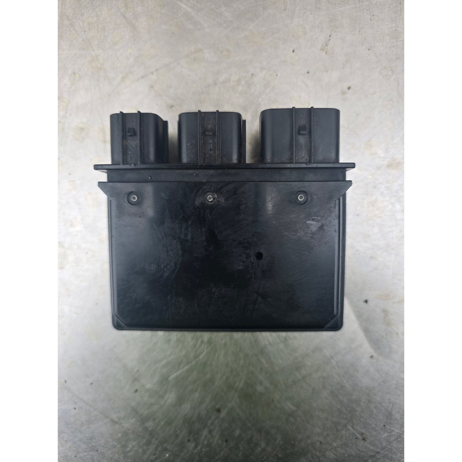 Bottom view of the relay box module showing mounting tabs with screw holes