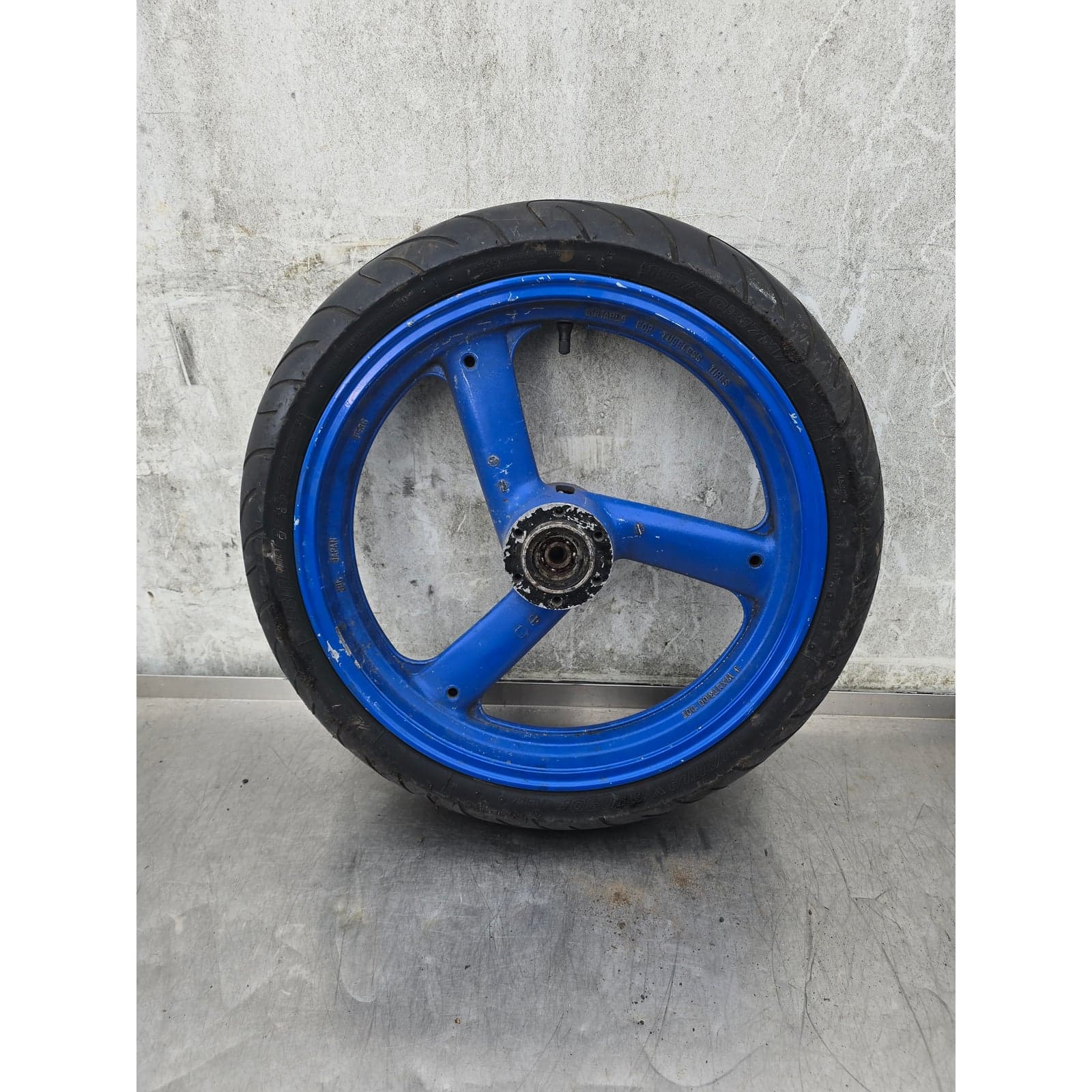 Yamaha 3-spoke blue front wheel assembly with Bridgestone tyre